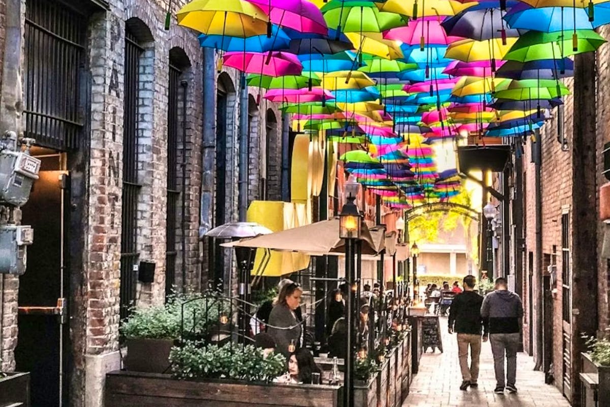 downtown Redlands' Umbrella alley with people dining and walking