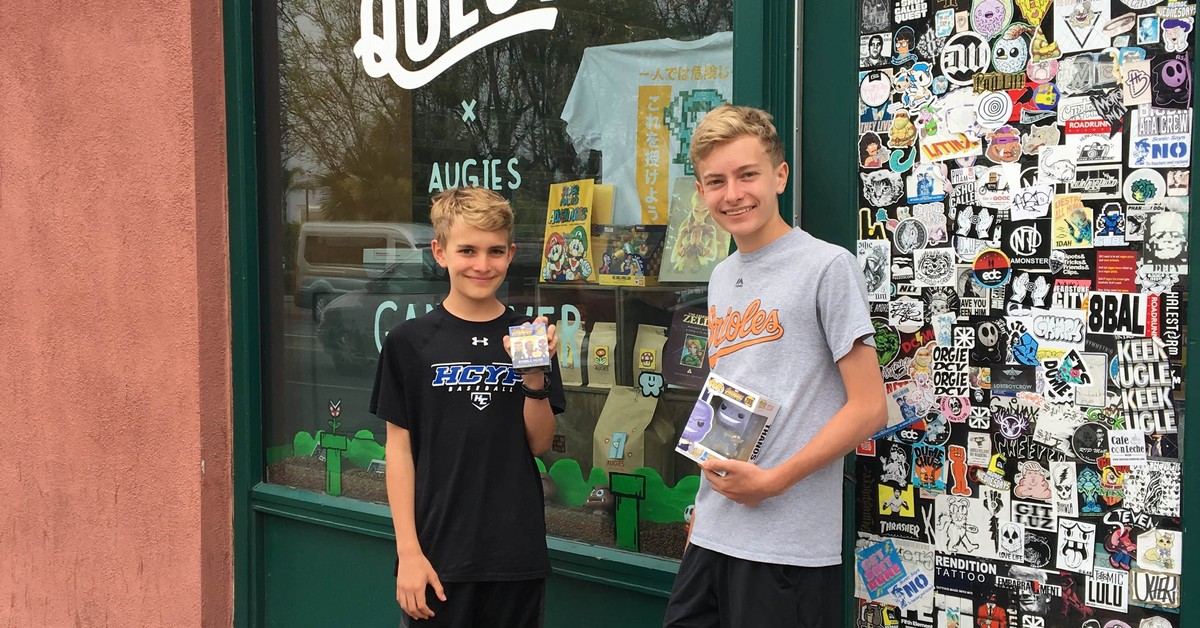 Aidan and Ian showing off their treasures from A Shop Called Quest