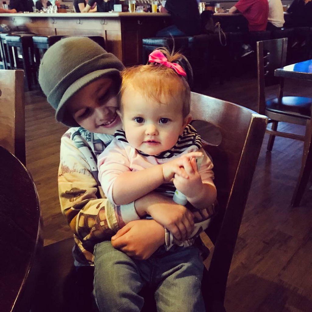 Two kids sitting at a restaurant
