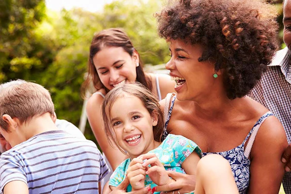 A family and friends gathering and enjoying a park