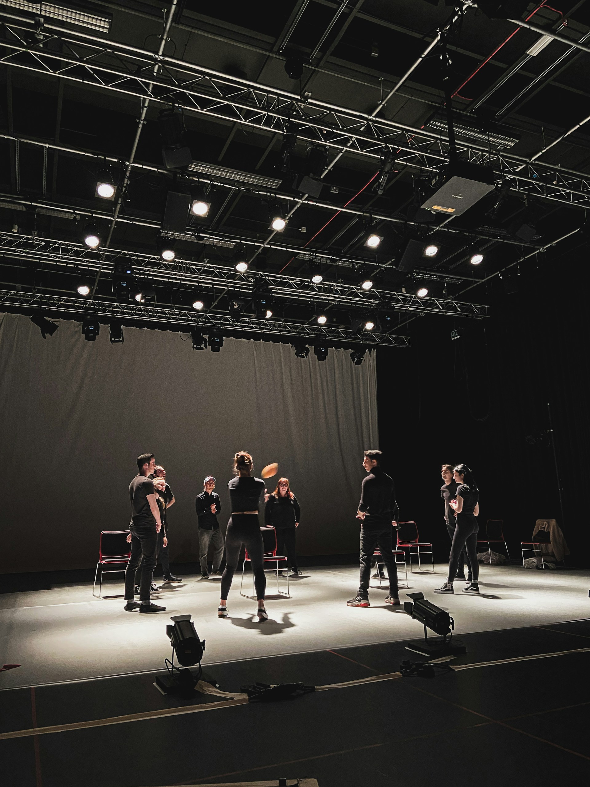 performers on a black box stage