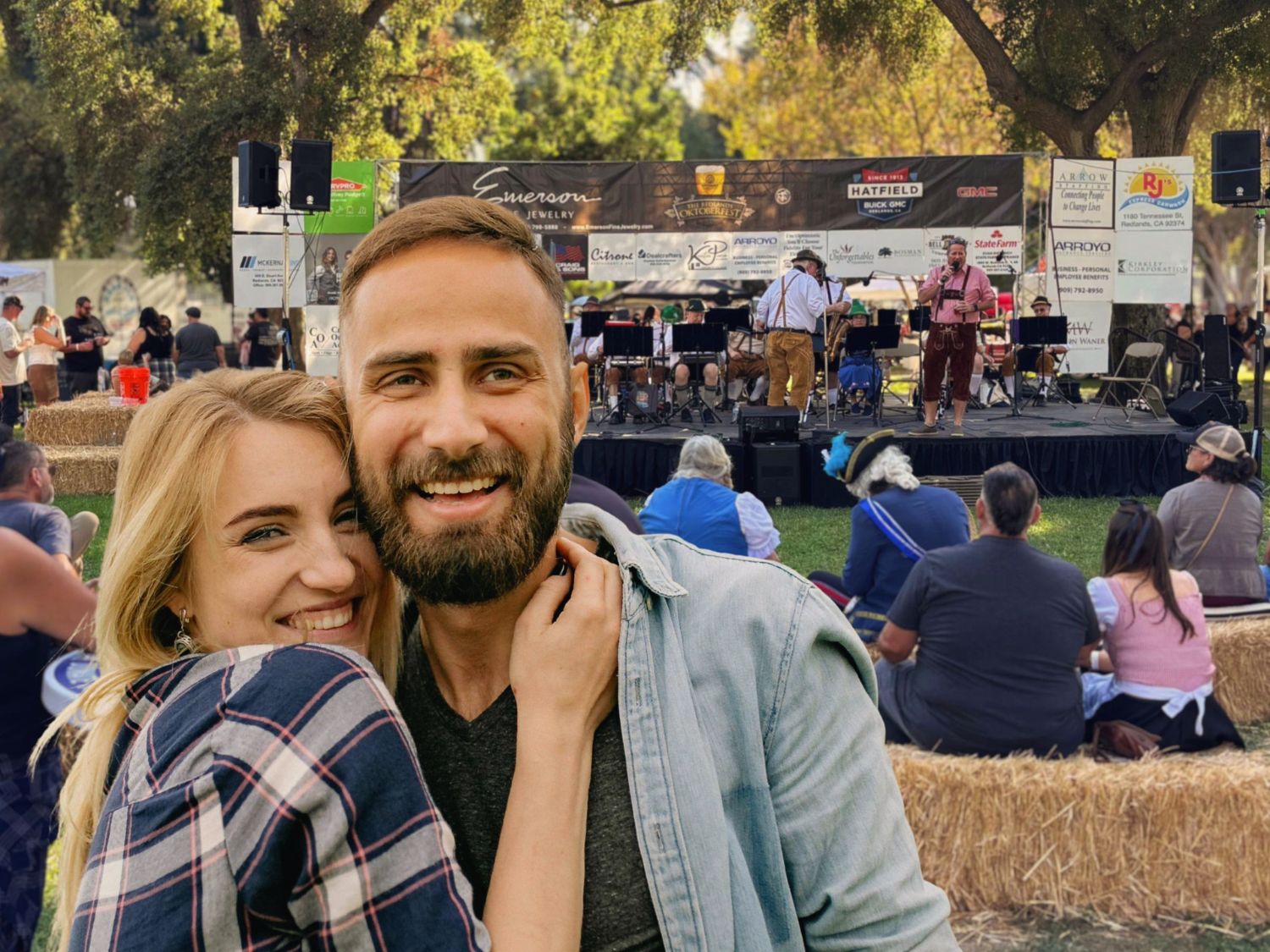 A happy couple at a park with live music in the background